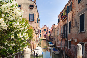Fototapeta na wymiar Canal in Venice and Church of Madonna dell'Orto in the distance. Cannaregio district of Venice, Italy