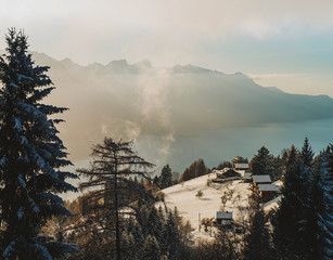 Mountain sunset over lake with evaporating snow