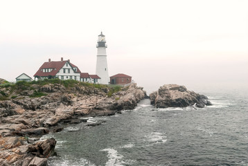 Fototapeta na wymiar The Portland Head Lighthouse, located on the coast of Maine, in the fog.