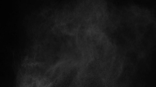 white vapour or spray water on a black background ,slow motion movement