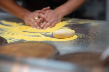 Worker making pizza in the restuarant