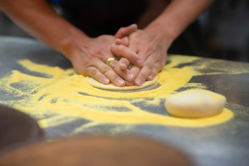 Worker making pizza in the restuarant