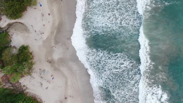 Aerial video of people surfing at the beach in Santa Teresa - Malpais, Costa Rica