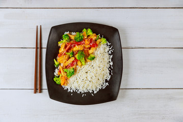 Asian stir fry meat, vegetables with white rice.