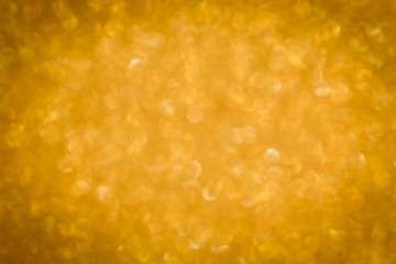 Gold background light. Golden glitter texture.