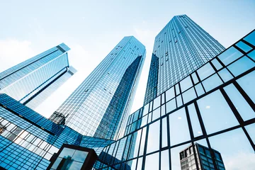 Deurstickers Modern skyscrapers in business district against blue sky © JFL Photography