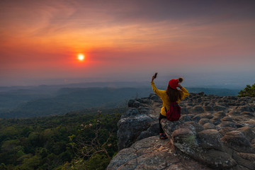 Young  woman hiking on mountains. Lan-hin-pum, Phu Hin Rong Kla National park, Phitsanulok province , Thailand.