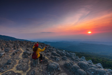 Young  woman hiking on mountains. Lan-hin-pum, Phu Hin Rong Kla National park, Phitsanulok province , Thailand.