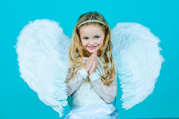 Valentines Day. Angel. Mischievous little angel girl standing with your clenched fists. Angels...