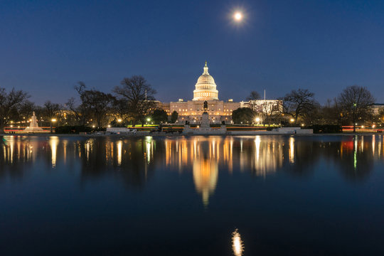 United States Capitol Building at twilight time with super full moon reflection with the big pool, Washington, DC, United States of America or USA, history and culture for travel concept - Powered by Adobe
