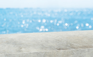 summer background.Empty diagonal grunge concrete table with blur sea and sky boekh...