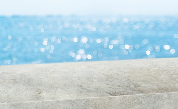 summer background.Empty diagonal grunge concrete table with blur sea and sky boekh background,banner mockup template for display of product