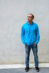 Obraz premium Portrait of mature Persian man wearing hoodie outdoors