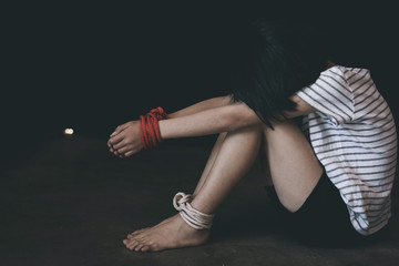 Kidnapped little girl tied with rope.Abused and tortured concept. Human trafficking concept.Stop...