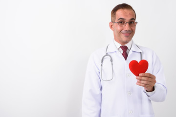 Portrait of mature handsome Persian man doctor