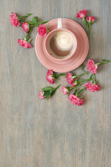 Cup of creamy coffee with flowers decor