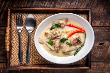 Chicken Coconut Soup (Tom Kha Gai),Coconut milk soup with chicken and Thai ingredients on the table, top view, Thai food that is popular in Thailand.