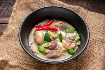 Chicken Coconut Soup (Tom Kha Gai),Coconut milk soup with chicken and Thai ingredients on the table, top view, Thai food that is popular in Thailand.