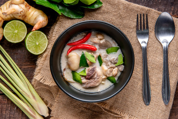 Chicken Coconut Soup (Tom Kha Gai),Coconut milk soup with chicken and Thai ingredients on the table, top view, Thai food that is popular in Thailand.
