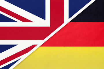 United Kingdom vs Germany national flag from textile. Relationship between two european countries.