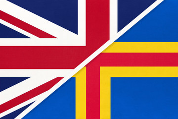 United Kingdom vs Aland Islands national flag from textile. Relationship between two european countries.