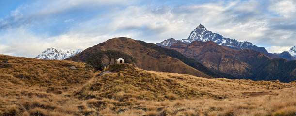 View of the small Hindu sanctuary against the background of the majestic Machapuchare and Mardi Himal. Nepal, the Himalayas.