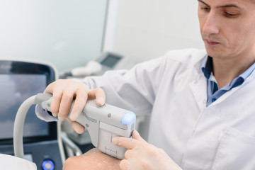 Closeup of male beautician doing mechanical cleaning of face to his client