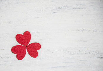Three red hearts forming a clover leaf.