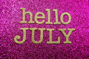 Hello July alphabet letters on pink glitter background