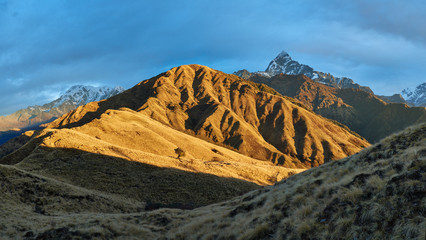 Panoramic views of Machapuchare and Mardi Himal illuminated by the dawn sun behind Korchen Hill, where the mountain shelter is located. Route to the eastern base camp of Mardi Himal.