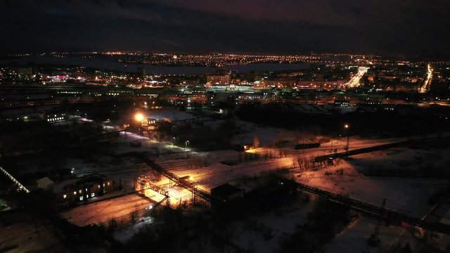 Top view of the night city in winter. Movement of cars on lighted streets and intersections