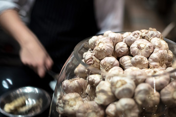 Bowl of pile garlic in kitchen