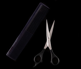 Hair cutting tools on a black background