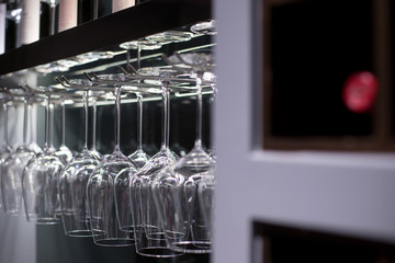 Glasses hanging over a bar rack