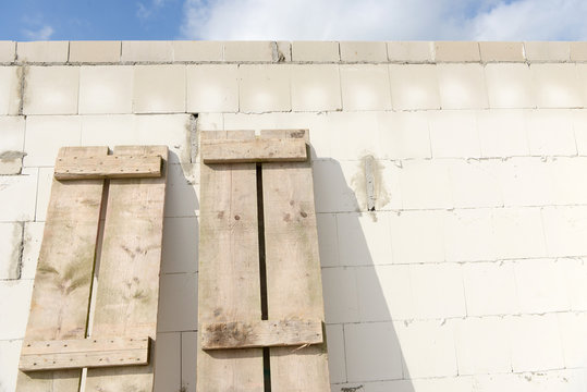 wooden scaffold boards at house wall on the construction site