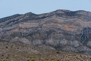 Low angle landscape of grey and black stone hillside at Red Rock Canyon Conservation Area in Las Vegas, Nevada