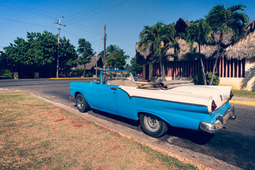 A classic retro car is parked on road in the resort town of Varadero. Cuba.