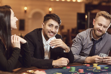 Friends gamble poker roulette in a casino