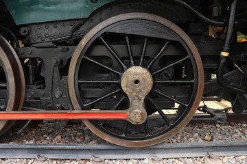 Fototapeta na wymiar A close of view of the wheels of a vintage train. Retro wheel of the old train on the railway. 