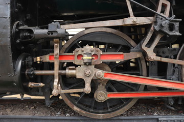 A close of view of the wheels of a vintage train. Retro wheel of the old train on the railway. 