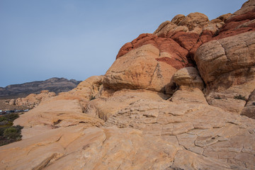 Low angle landscape of large white and red rock formations or hills at Red Rock Canyon Conservation Area in Las Vegas, Nevada
