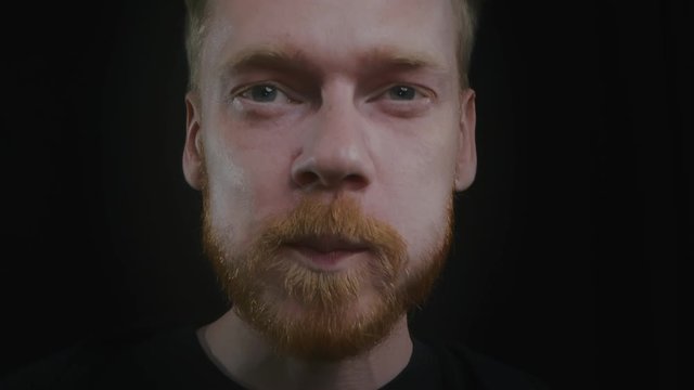 Macro portrait of young man drinking alcohol