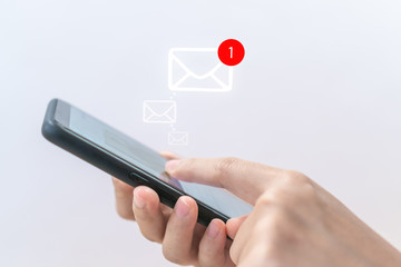 Woman hand use smartphone in public area with 1 new email alert sign icon pop up. Communication...