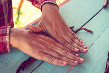 Cuban cowboy is making a cigar for tourists. Closeup of hands making cigar from tobacco leaves....