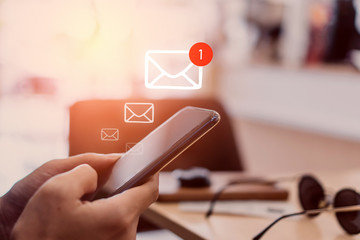 Woman hand use smartphone in public area with 1 new email alert sign icon pop up. Communication...