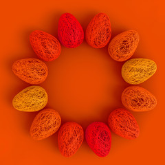 Easter concept. On an orange background a lot of eggs woven from intertwined all shades of orange and yellow threads laid out in a circle with an empty space in the center. 3D stock illustration.