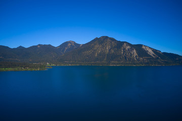 Fototapeta na wymiar Lake Walchensee, Germany. Clear blue sky, morning on the lake. Lake in Germany. Aerial view