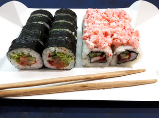 Close-up of a set of sushi with soy sauce on an abstract surface