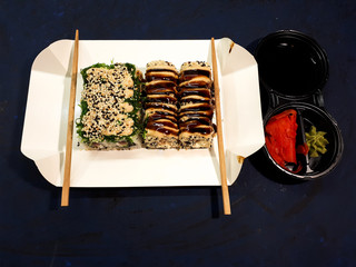 Close-up of a set of sushi with soy sauce on an abstract surface