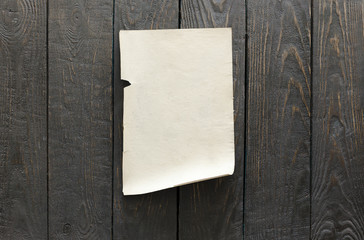 old paper on dark wooden wall